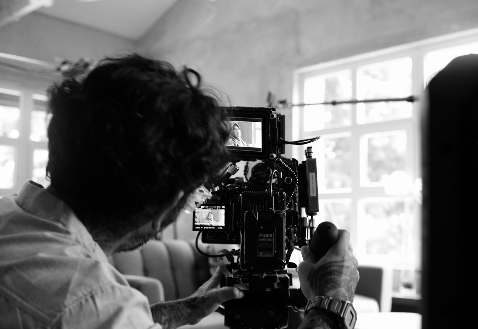 Camera operator working hands-on with a cinema camera, capturing the deep expertise of veteran crew